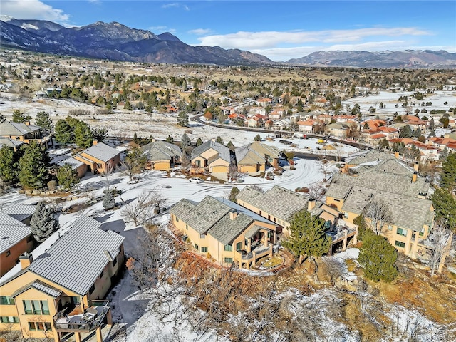 snowy aerial view with a mountain view