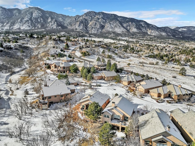 snowy aerial view with a mountain view