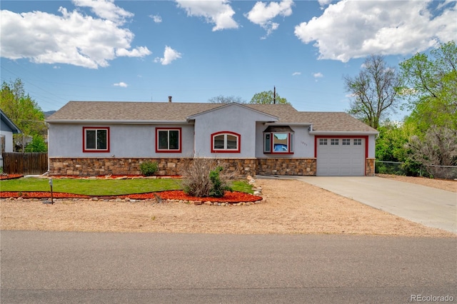 1035 Quartz St, Golden, CO 80401 - ranch-style house featuring stone siding, stucco siding, a garage, and concrete driveway