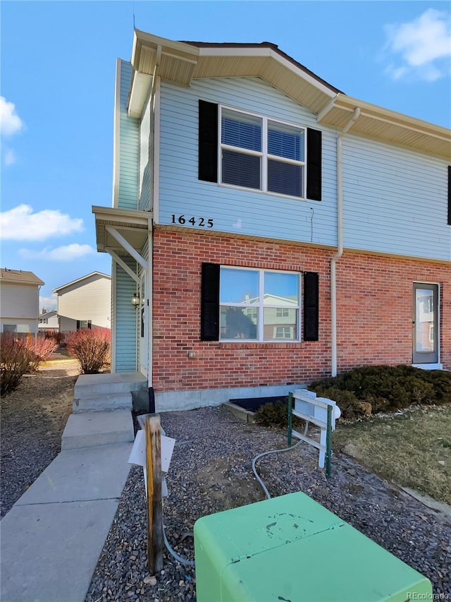 view of front of house featuring brick siding