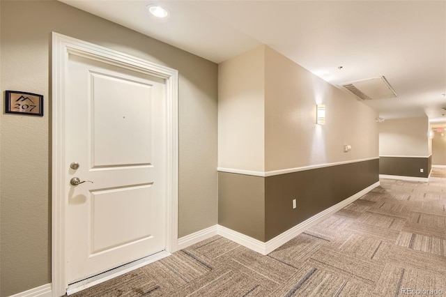 corridor with carpet floors and baseboards