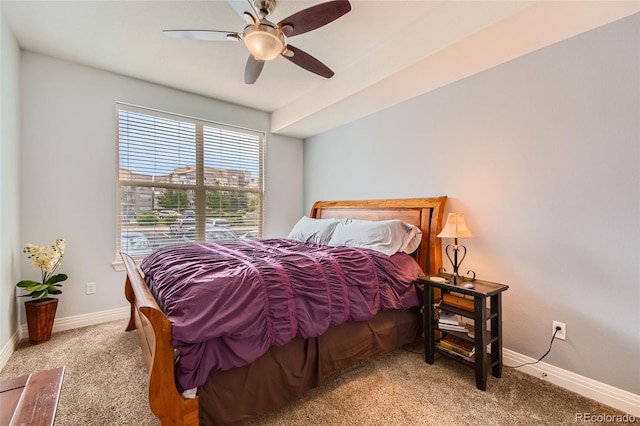 bedroom featuring a ceiling fan, light colored carpet, and baseboards