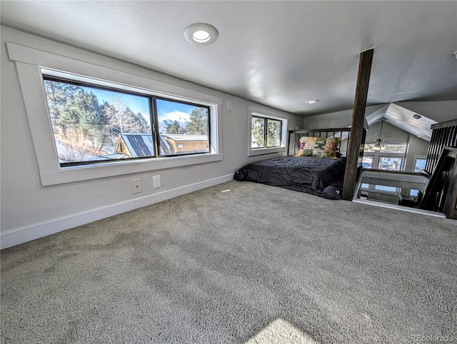 bedroom featuring carpet floors and vaulted ceiling