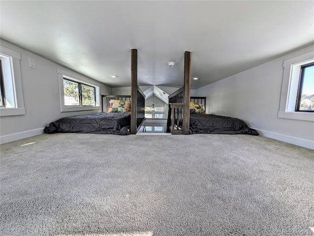 unfurnished bedroom featuring carpet and lofted ceiling