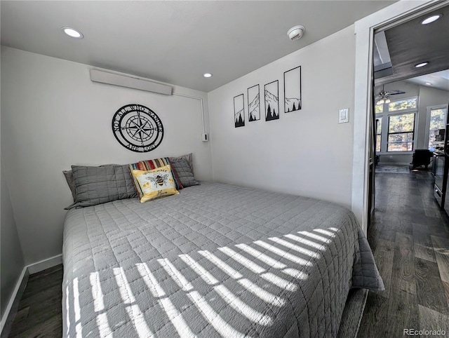 bedroom with dark hardwood / wood-style floors