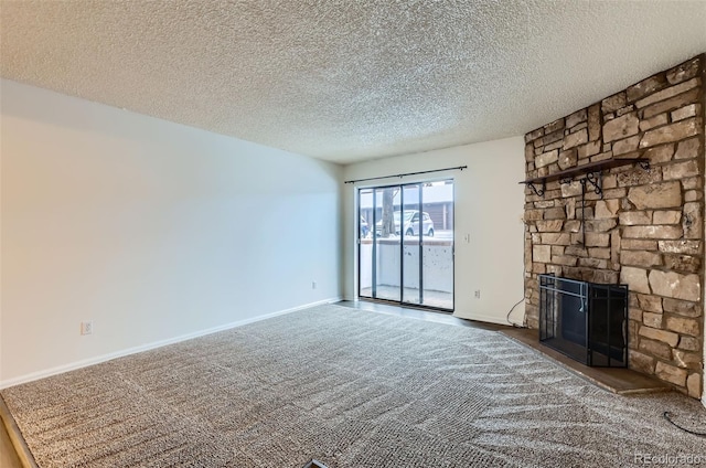 unfurnished living room with a textured ceiling, carpet floors, and a fireplace