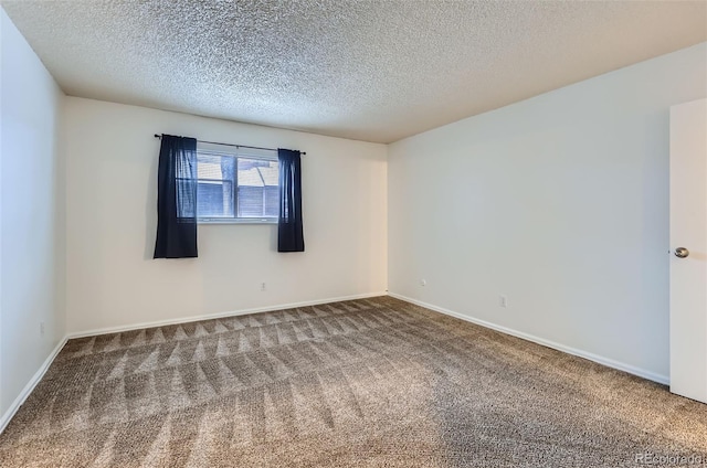 carpeted spare room featuring a textured ceiling