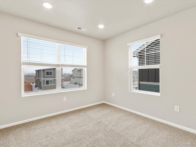 spare room with carpet flooring and a healthy amount of sunlight