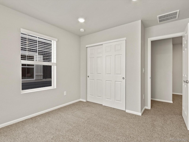 unfurnished bedroom featuring a closet and carpet floors