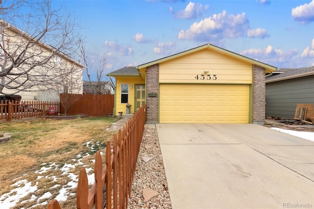 single story home featuring a front yard and a garage