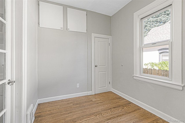 empty room with hardwood / wood-style flooring