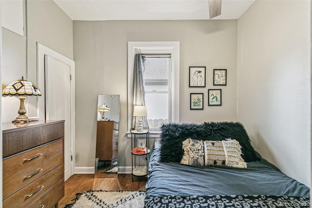 bedroom featuring ceiling fan and dark hardwood / wood-style floors