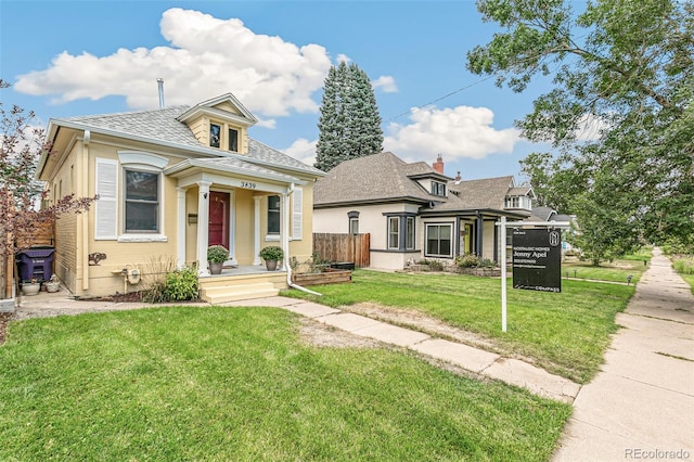 bungalow-style home with a front lawn