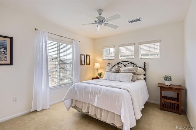 bedroom featuring ceiling fan and light carpet