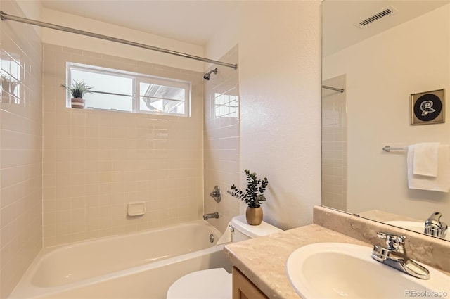 full bathroom featuring vanity, toilet, and tiled shower / bath