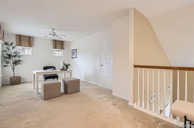 carpeted office featuring ceiling fan