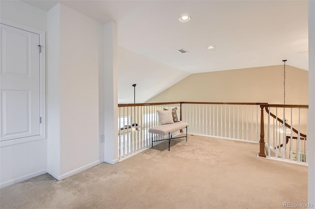 interior space with carpet and vaulted ceiling