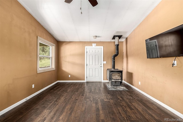 435 Sourwood Ln, Canon City, CO 81212 - unfurnished living room with a ceiling fan, wood finished floors, and a wood stove