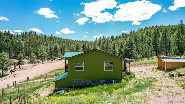435 Sourwood Ln, Canon City, CO 81212 - view of side of property with a wooded view and a metal roof