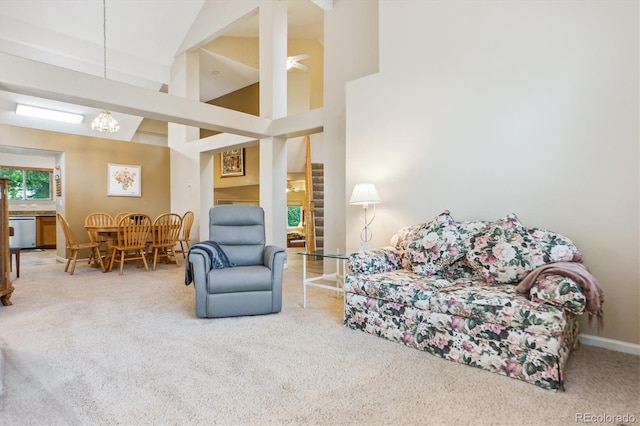 6534 S Union Way, Littleton, CO 80127 - living area featuring carpet flooring, high vaulted ceiling, baseboards, and a chandelier