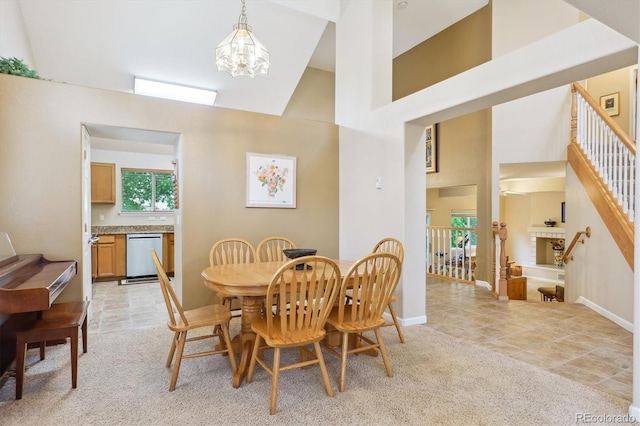 6534 S Union Way, Littleton, CO 80127 - dining area with a towering ceiling, a chandelier, baseboards, and light colored carpet