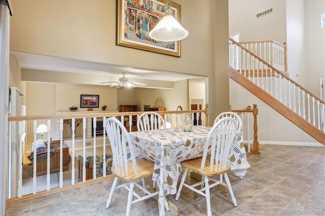 6534 S Union Way, Littleton, CO 80127 - dining room featuring a ceiling fan, a towering ceiling, stairway, and baseboards