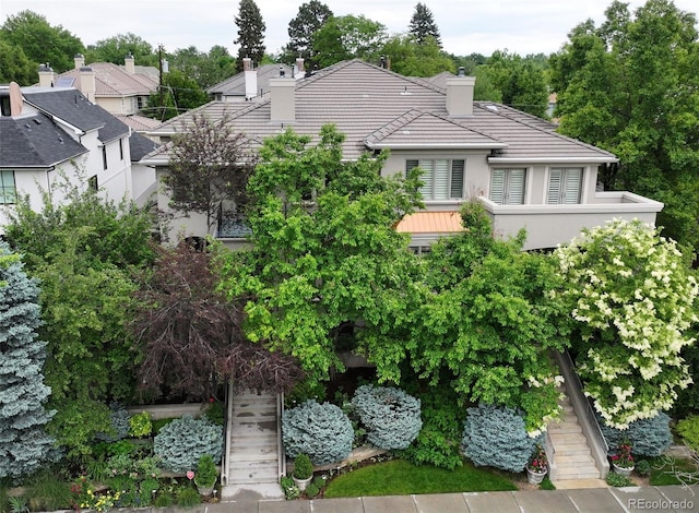458 Adams St, Denver, CO 80206 - view of front of property with a chimney, a tiled roof, and stucco siding