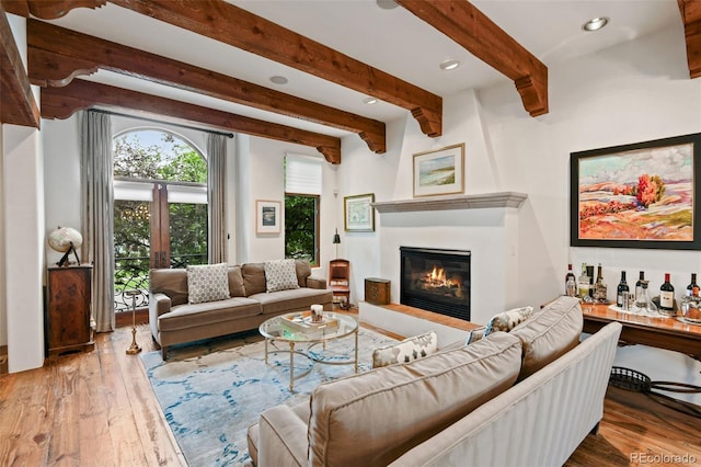 458 Adams St, Denver, CO 80206 - living area featuring a large fireplace, beamed ceiling, wood-type flooring, and recessed lighting