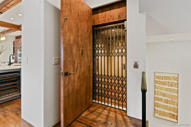 458 Adams St, Denver, CO 80206 - wine area featuring wine cooler, wood finished floors, a sink, recessed lighting, and beamed ceiling