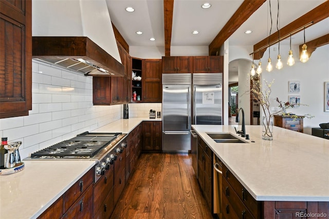 458 Adams St, Denver, CO 80206 - kitchen featuring custom exhaust hood, appliances with stainless steel finishes, a sink, beamed ceiling, and dark wood-style floors