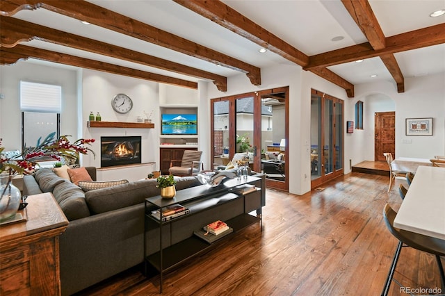 458 Adams St, Denver, CO 80206 - living area with beamed ceiling, arched walkways, a glass covered fireplace, hardwood / wood-style flooring, and recessed lighting