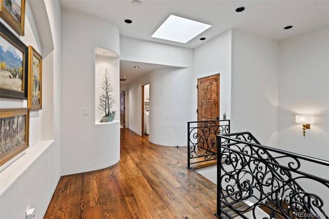 458 Adams St, Denver, CO 80206 - hallway featuring a skylight, an upstairs landing, wood finished floors, and recessed lighting