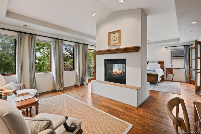 458 Adams St, Denver, CO 80206 - living area with a multi sided fireplace, recessed lighting, wood finished floors, lofted ceiling, and a raised ceiling