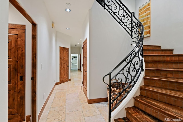 458 Adams St, Denver, CO 80206 - stairs with baseboards, stone tile flooring, and recessed lighting