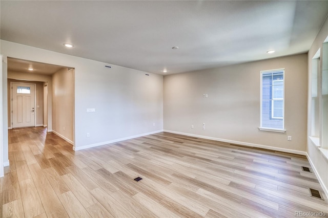 spare room featuring light hardwood / wood-style floors