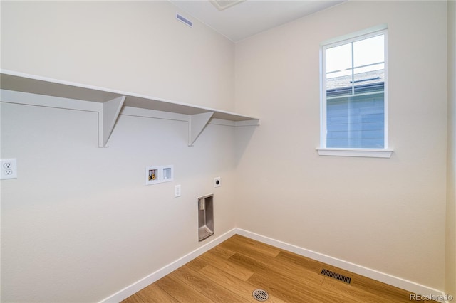 clothes washing area featuring hookup for an electric dryer, light hardwood / wood-style flooring, and hookup for a washing machine