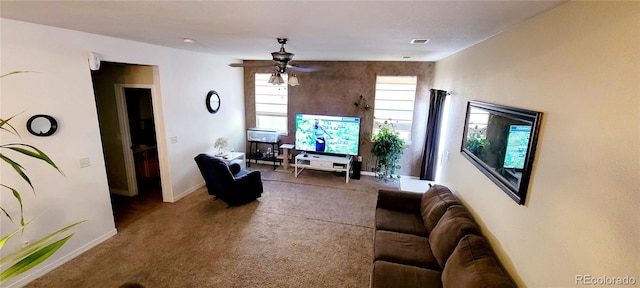 living room with ceiling fan and carpet