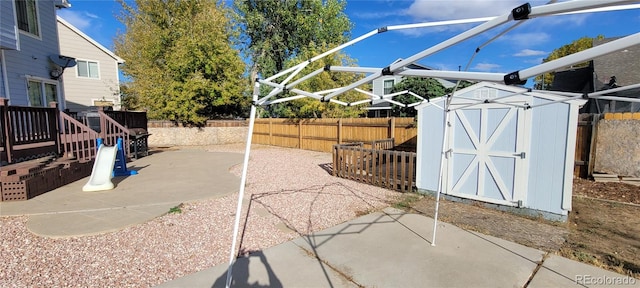 view of patio featuring a storage unit