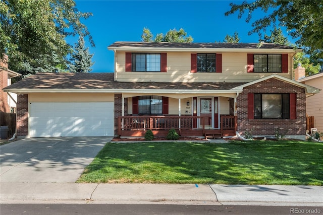 view of property with a garage, a front lawn, and covered porch