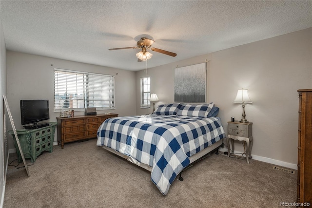 bedroom featuring carpet floors, a textured ceiling, and ceiling fan