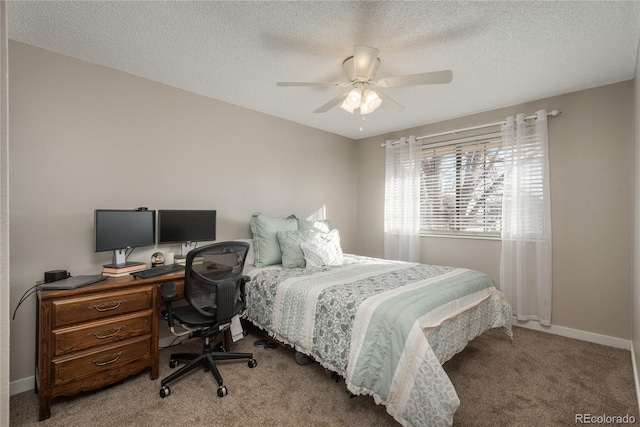 carpeted bedroom featuring ceiling fan and a textured ceiling