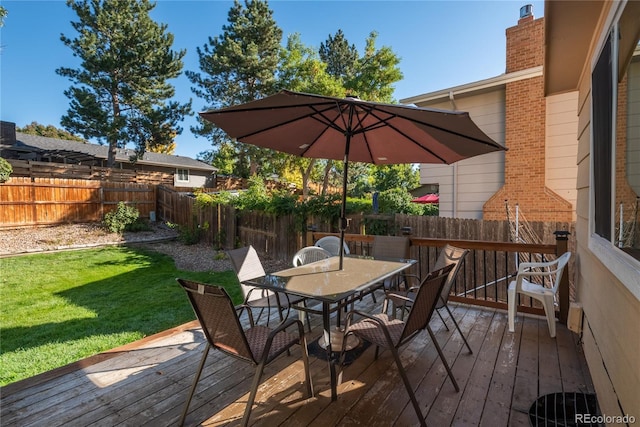 wooden terrace featuring a lawn