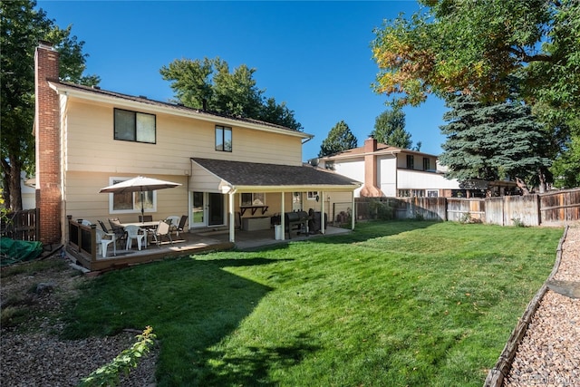 rear view of property with a patio area and a lawn