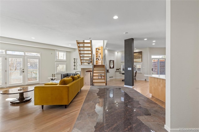 living room with light wood-type flooring and a large fireplace