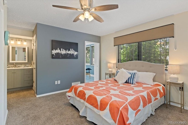 534 E 7th Ave Unit 101, Denver, CO 80203 - bedroom featuring baseboards, a textured ceiling, carpet flooring, ensuite bathroom, and a ceiling fan