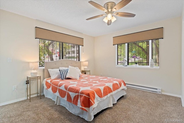 534 E 7th Ave Unit 101, Denver, CO 80203 - carpeted bedroom featuring baseboard heating, baseboards, and ceiling fan