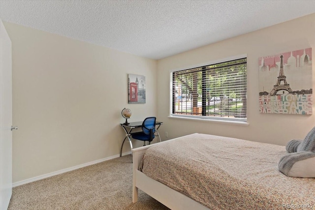 534 E 7th Ave Unit 101, Denver, CO 80203 - bedroom featuring carpet floors, a textured ceiling, and baseboards