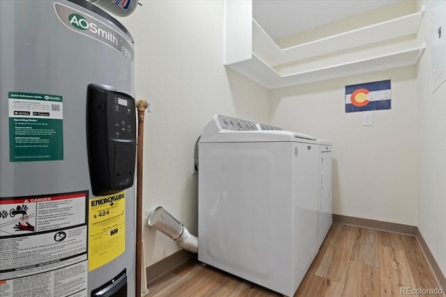 534 E 7th Ave Unit 101, Denver, CO 80203 - laundry room with water heater, washer and clothes dryer, light wood-type flooring, and baseboards