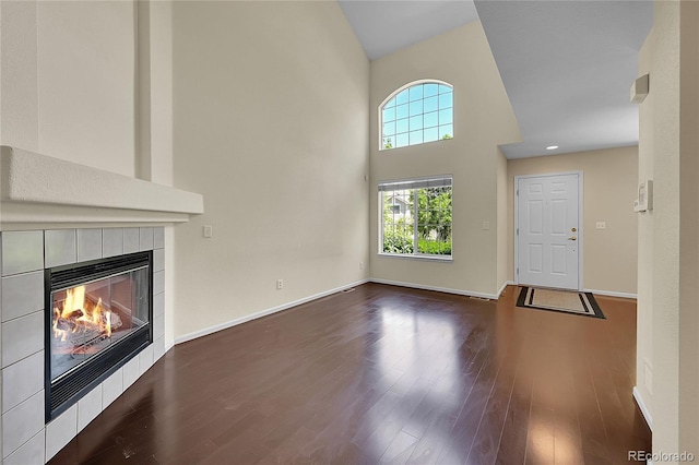 4006 E Geddes Cir, Centennial, CO 80122 - unfurnished living room with high vaulted ceiling, wood finished floors, and a fireplace