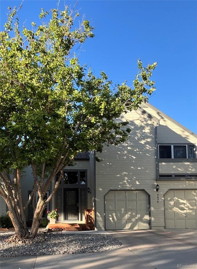5479 E Weaver Ave, Centennial, CO 80121 - view of front of house featuring a garage, concrete driveway, and brick siding